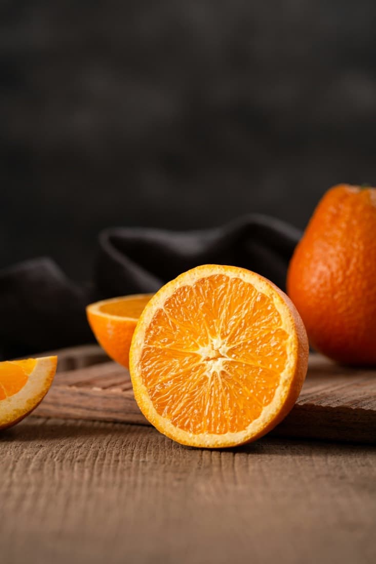 Juicy orange slices on a wooden board